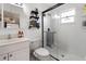 Clean and modern bathroom with shower, and sink and a black framed mirror, plus tiled floors at 1108 16Th Nw Ave, Clearwater, FL 33756
