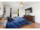 Bedroom features a large window with natural light, hardwood floors, ceiling fan and a dark wood dresser at 1108 16Th Nw Ave, Clearwater, FL 33756
