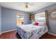 Comfortable bedroom featuring hardwood floors, a ceiling fan and two windows with natural light at 1108 16Th Nw Ave, Clearwater, FL 33756