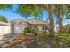 Charming single-story home featuring a well-manicured lawn, mature trees, and an attached one-car garage at 1108 16Th Nw Ave, Clearwater, FL 33756