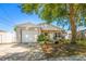 Charming single-story home featuring a well-manicured lawn, mature trees, and an attached one-car garage at 1108 16Th Nw Ave, Clearwater, FL 33756
