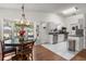 Bright kitchen featuring white cabinetry, stainless steel appliances, and an adjacent dining area at 1108 16Th Nw Ave, Clearwater, FL 33756