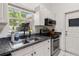 Well-lit kitchen with stainless steel appliances, white cabinets, and sleek countertops at 1108 16Th Nw Ave, Clearwater, FL 33756