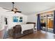Bright living room featuring hardwood floors, sliding glass doors to patio, and a cozy seating area with ceiling fan at 1108 16Th Nw Ave, Clearwater, FL 33756