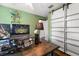 Cozy home office featuring a modern desk with a baseball game on the laptop and barn door closet at 1108 16Th Nw Ave, Clearwater, FL 33756