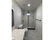 Bathroom featuring modern tiling in the shower, a new toilet, and a contemporary vanity for an updated look at 112 N Betty Ln, Clearwater, FL 33755
