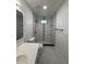 The renovated bathroom features a walk-in shower, updated vanity, and modern finishes at 112 N Betty Ln, Clearwater, FL 33755