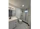 The renovated bathroom includes a walk-in shower, new fixtures, and modern finishes at 112 N Betty Ln, Clearwater, FL 33755
