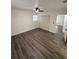Bedroom with wood-look flooring, ceiling fan, and a closet providing a comfortable living space at 112 N Betty Ln, Clearwater, FL 33755