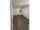 This is a simply decorated bedroom with wood-look flooring and fresh paint at 112 N Betty Ln, Clearwater, FL 33755