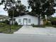 Charming single story home featuring mature trees and a large front yard at 112 N Betty Ln, Clearwater, FL 33755