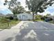 Charming single-story home with a concrete driveway and well-maintained front yard landscaping at 112 N Betty Ln, Clearwater, FL 33755