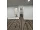 Hallway featuring updated flooring that creates a seamless transition between rooms and a bathroom doorway at 112 N Betty Ln, Clearwater, FL 33755