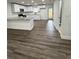Modern kitchen boasts white cabinets, granite countertops, and stainless steel appliances with wood-look flooring at 112 N Betty Ln, Clearwater, FL 33755