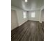 The living room has lots of natural light, fresh paint and wood-look flooring at 112 N Betty Ln, Clearwater, FL 33755