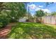 The backyard boasts a lush lawn bordered by a mix of wood and vinyl fencing for privacy at 1340 Whispering Pines Dr, Clearwater, FL 33764
