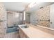 Bathroom with bathtub and shower, floral wallpaper, and vanity with integrated blue sink basin at 1340 Whispering Pines Dr, Clearwater, FL 33764