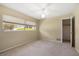 Bedroom featuring natural light from two windows, neutral walls, ceiling fan, and closet at 1340 Whispering Pines Dr, Clearwater, FL 33764