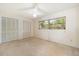 Bedroom with 2 large closets, large window, and ceiling fan at 1340 Whispering Pines Dr, Clearwater, FL 33764