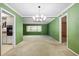 Formal dining room with modern chandelier and view to kitchen and Gathering room at 1340 Whispering Pines Dr, Clearwater, FL 33764