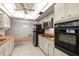Eat-in kitchen featuring stainless steel appliances and a white tile floor and backsplash at 1340 Whispering Pines Dr, Clearwater, FL 33764