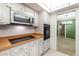 Kitchen featuring stainless steel microwave and cook top at 1340 Whispering Pines Dr, Clearwater, FL 33764