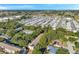An aerial view showcases a dense mobile home park, interspersed with trees, creating a unique residential landscape at 13777 Forest Lake Dr, Largo, FL 33771