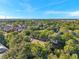 An aerial shot of a housing community surrounded by trees and greenery at 13777 Forest Lake Dr, Largo, FL 33771