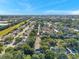 An aerial photo revealing a serene neighborhood nestled among trees under a bright blue sky at 13777 Forest Lake Dr, Largo, FL 33771