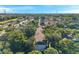 An aerial view of a community complex surrounded by lush greenery beneath a clear blue sky at 13777 Forest Lake Dr, Largo, FL 33771