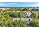 Aerial view of the home nestled amongst mature trees in a quiet neighborhood at 13777 Forest Lake Dr, Largo, FL 33771