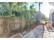 The property offers a landscaped backyard with mature trees, a new fence, and a paved walkway at 13777 Forest Lake Dr, Largo, FL 33771