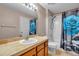 Full bathroom with travertine tile, cultured marble countertop, and tub/shower combo with tiled enclosure at 13777 Forest Lake Dr, Largo, FL 33771