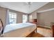 Bedroom featuring wood floors, ceiling fan, and windows with neighborhood views at 13777 Forest Lake Dr, Largo, FL 33771