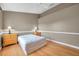 Neutral bedroom featuring wood flooring, ceiling fan, and decorative lamps on matching wood bedside tables at 13777 Forest Lake Dr, Largo, FL 33771