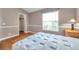 This bedroom features wood laminate floors, and a large window for natural light at 13777 Forest Lake Dr, Largo, FL 33771