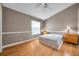 Simple bedroom with wood laminate flooring, a ceiling fan, and a large window for natural light at 13777 Forest Lake Dr, Largo, FL 33771