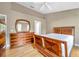 Bedroom with wood floors, bright windows, and a matching dresser with mirror at 13777 Forest Lake Dr, Largo, FL 33771