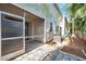 Exterior of home featuring a screened in patio leading to a landscaped and fenced yard at 13777 Forest Lake Dr, Largo, FL 33771