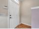 View of white front door with dark hardware and light-colored walls at 13777 Forest Lake Dr, Largo, FL 33771