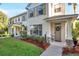 Inviting townhouse facade with well-maintained lawn and manicured landscaping at 13777 Forest Lake Dr, Largo, FL 33771