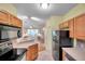 Kitchen leading into well lit living room area at 13777 Forest Lake Dr, Largo, FL 33771