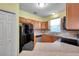 Efficient kitchen features wood cabinets, modern appliances, and plenty of counter space at 13777 Forest Lake Dr, Largo, FL 33771