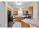 Well-appointed kitchen featuring stainless steel appliances, wood cabinets, and ample counter space at 13777 Forest Lake Dr, Largo, FL 33771