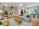 Open-concept living room with hardwood floors, staircase, and seamless flow to dining and kitchen areas at 13777 Forest Lake Dr, Largo, FL 33771