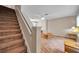This living room features a staircase with carpeted steps and wood laminate flooring at 13777 Forest Lake Dr, Largo, FL 33771