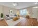 Cozy living room featuring hardwood floors, ample natural light, and comfortable seating at 13777 Forest Lake Dr, Largo, FL 33771