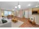 Bright living room with hardwood floors, modern lighting, and dining table and kitchen area at 13777 Forest Lake Dr, Largo, FL 33771