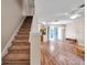 Living room features a staircase, sliding door access to the outdoors, and hard wood flooring at 13777 Forest Lake Dr, Largo, FL 33771