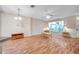 Bright living room with wood floors, fan, and abundant natural light through the window at 13777 Forest Lake Dr, Largo, FL 33771